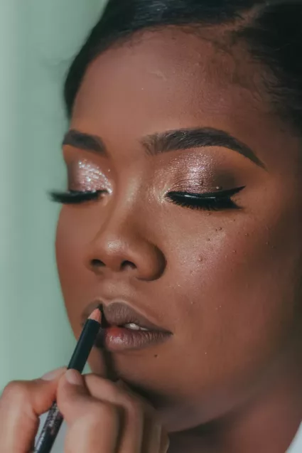 Bride getting makeup put on before wedding